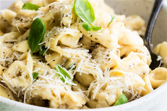 Tortellini prosciutto funghi (pasta gevuld met vlees)